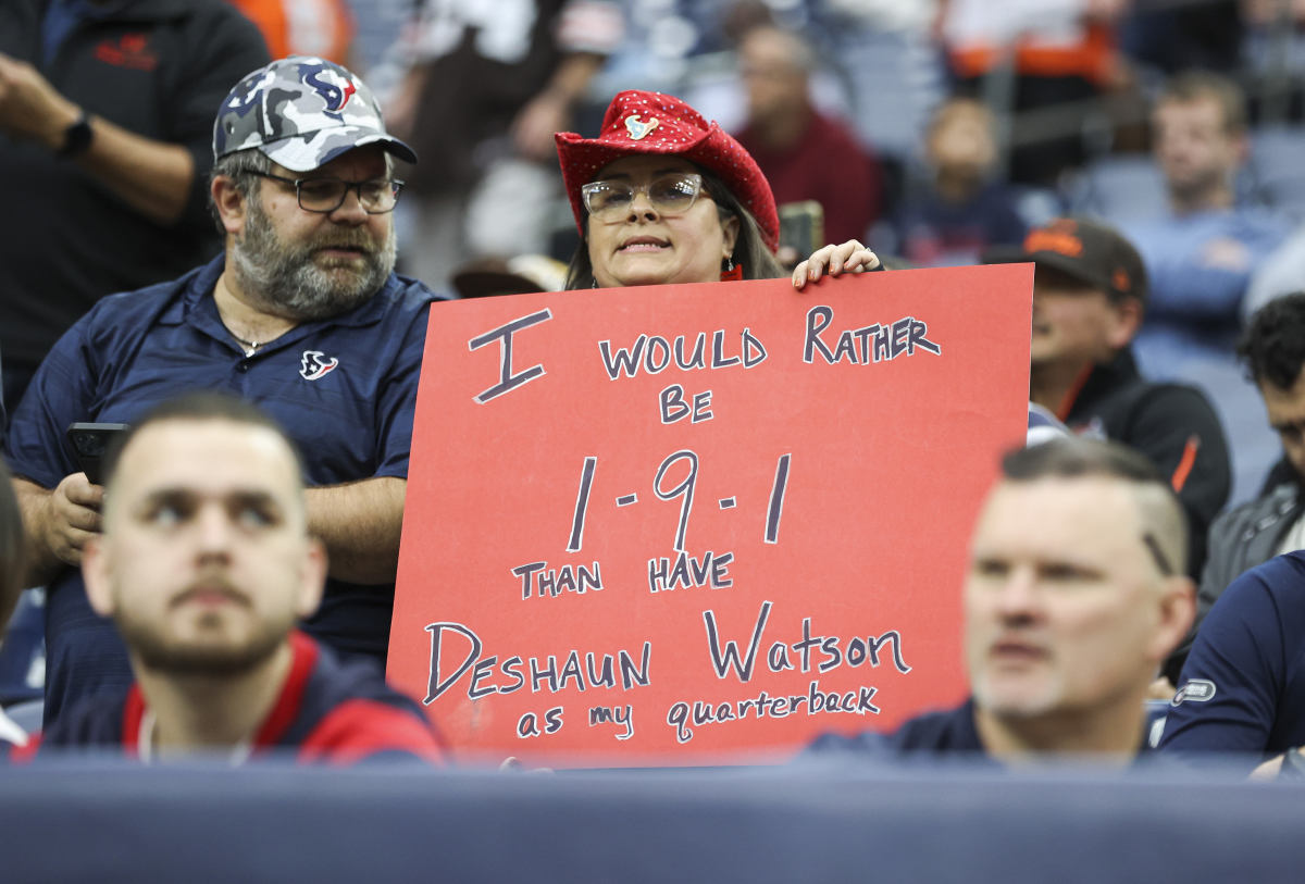 A Texans fan holds up an anti-Deshaun Watson sign